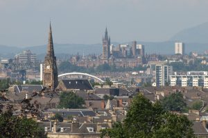 View of the city of Glasgow with church towers, buildings and a bridge