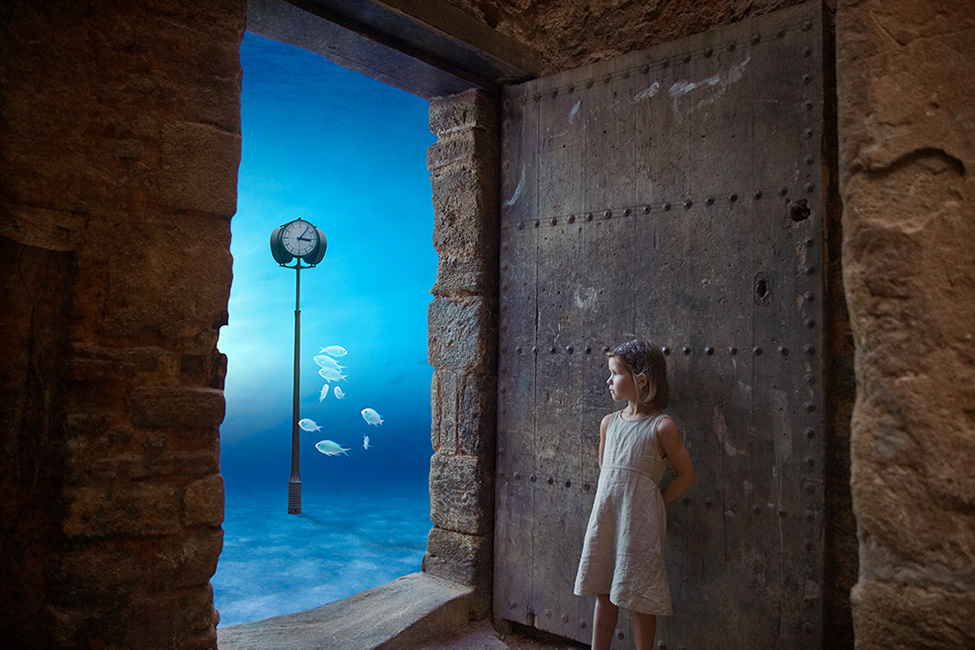 Photo montage of a child standing by a door looking out onto the ocean floor with a clock