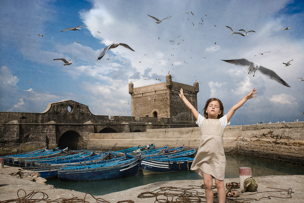 Photo montage of a child arms outstretched like a bird